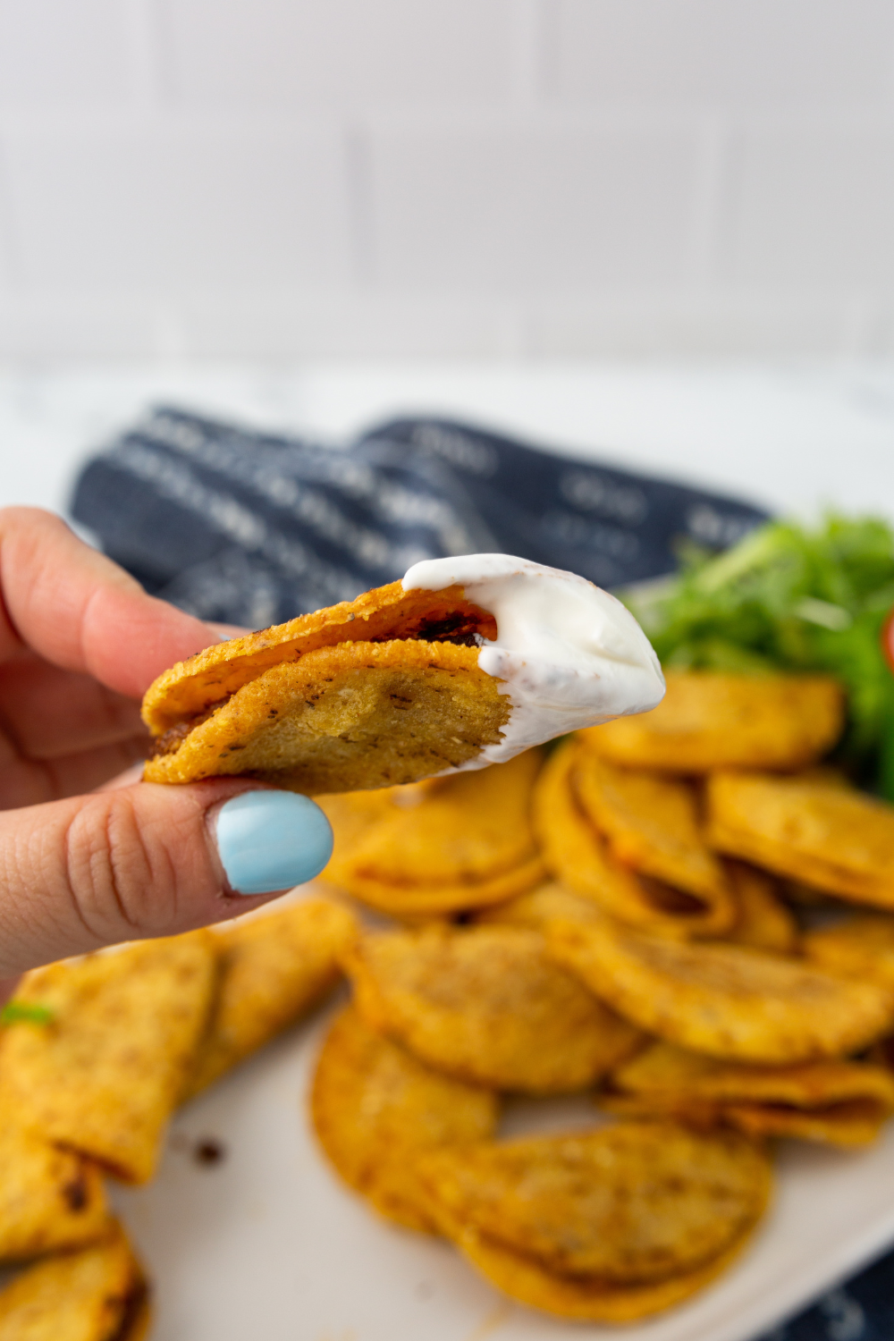 air fryer Trader Joe’s mini chicken tacos crispy golden shell served on plate with dip