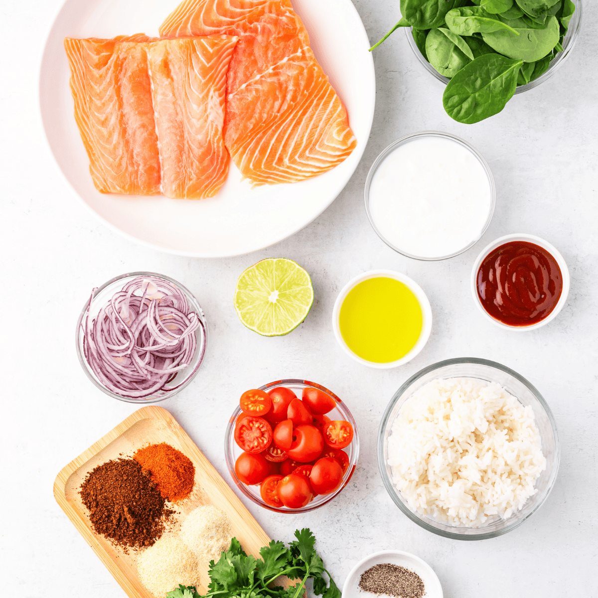 Ingredients for air fryer cedar plank salmon including salmon fillets, olive oil, lemon, garlic powder, paprika, and fresh dill