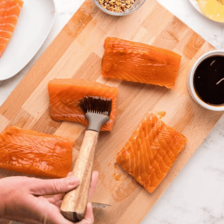 Salmon fillets seasoned with paprika, garlic powder, salt, and pepper before air frying