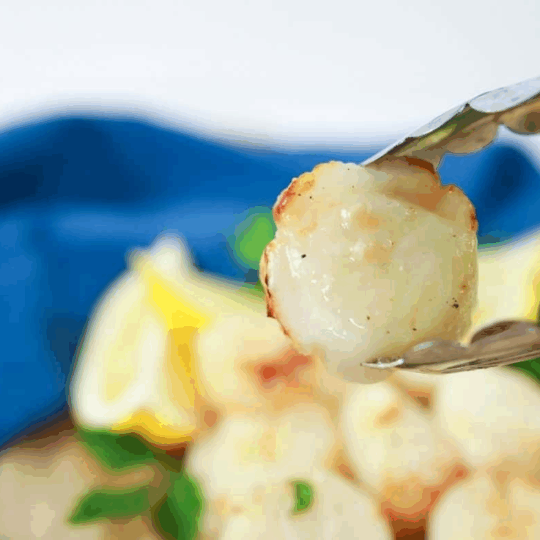 Golden-brown air fryer frozen scallops served on a plate, ready to eat.
