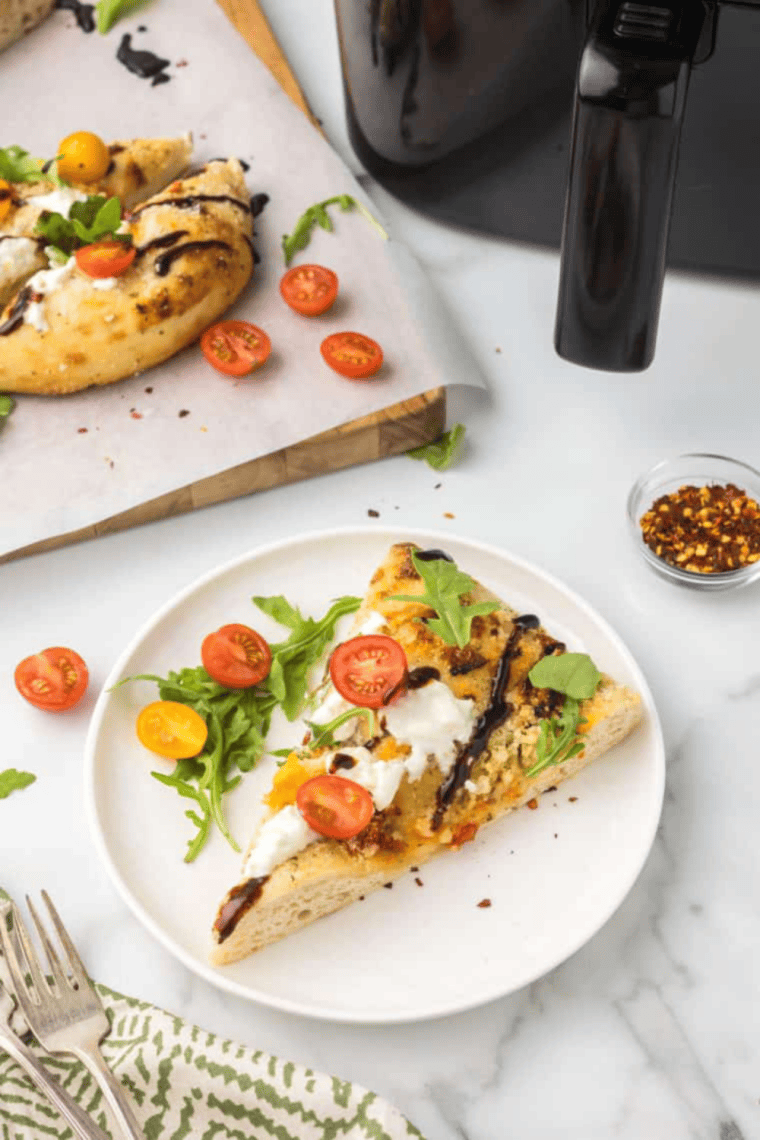Golden air fryer focaccia topped with creamy burrata, fresh arugula, and cherry tomatoes