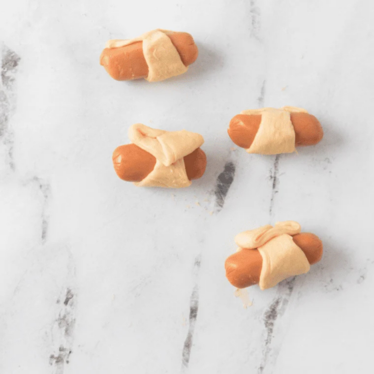 Wrapped smokies brushed with egg wash and sprinkled with sesame seeds