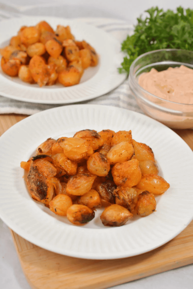 Crispy air fryer blooming onion bites served as an appetizer with creamy dip