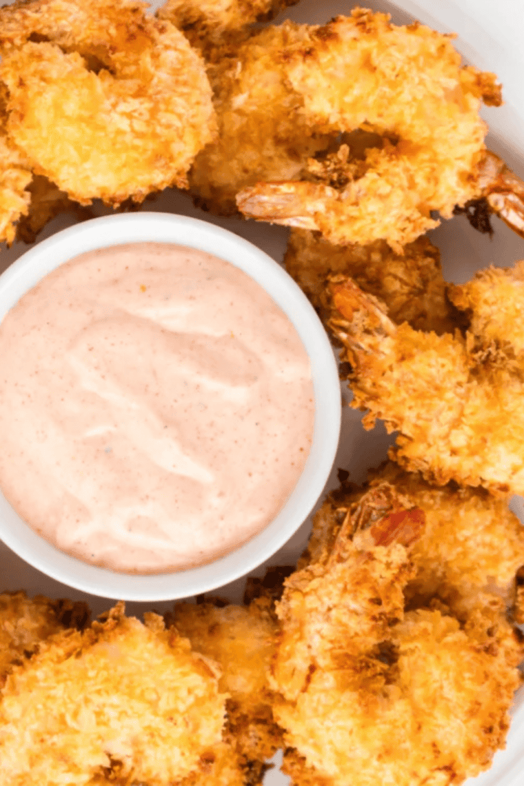 Plate of crispy air fryer panko fried shrimp with sauce.