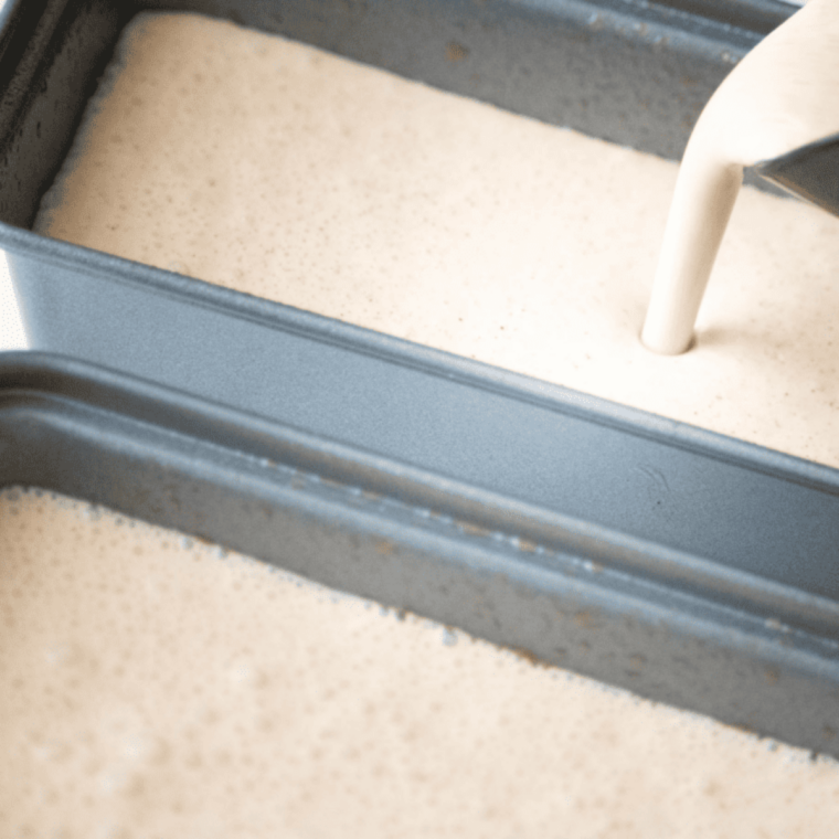 Egg mixture poured into greased air fryer-safe dish, surface smoothed with spatula.