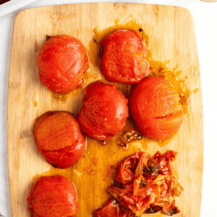 Finished air fryer roasted Roma tomatoes resting before serving, jammy and caramelized