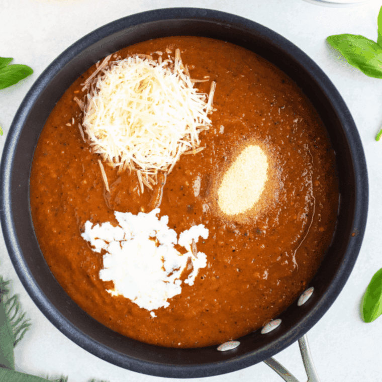 Simmer the soup, on the stove, combining all of the flavors together.