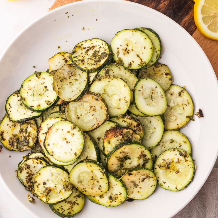 Charred Blackstone griddle zucchini served on plate with golden edges and tender centers for quick healthy side dish