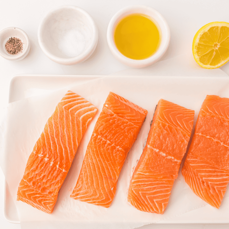 Ingredients for air fryer honey orange glazed salmon: salmon fillets, honey, orange juice, soy sauce, garlic, and ginger.