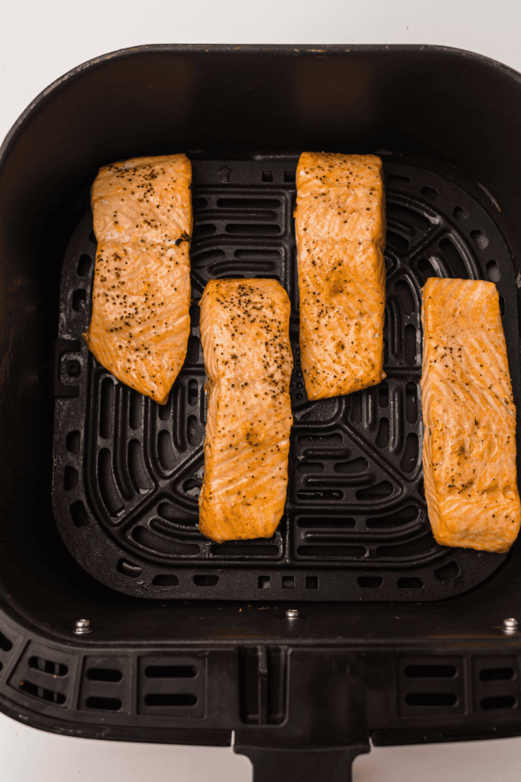 Cooked honey orange glazed salmon on a plate, ready to serve or refrigerate.