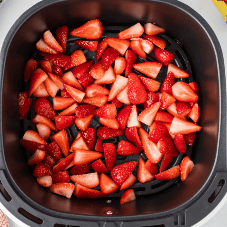 Air fryer strawberry candy slices arranged in a single layer in the air fryer basket