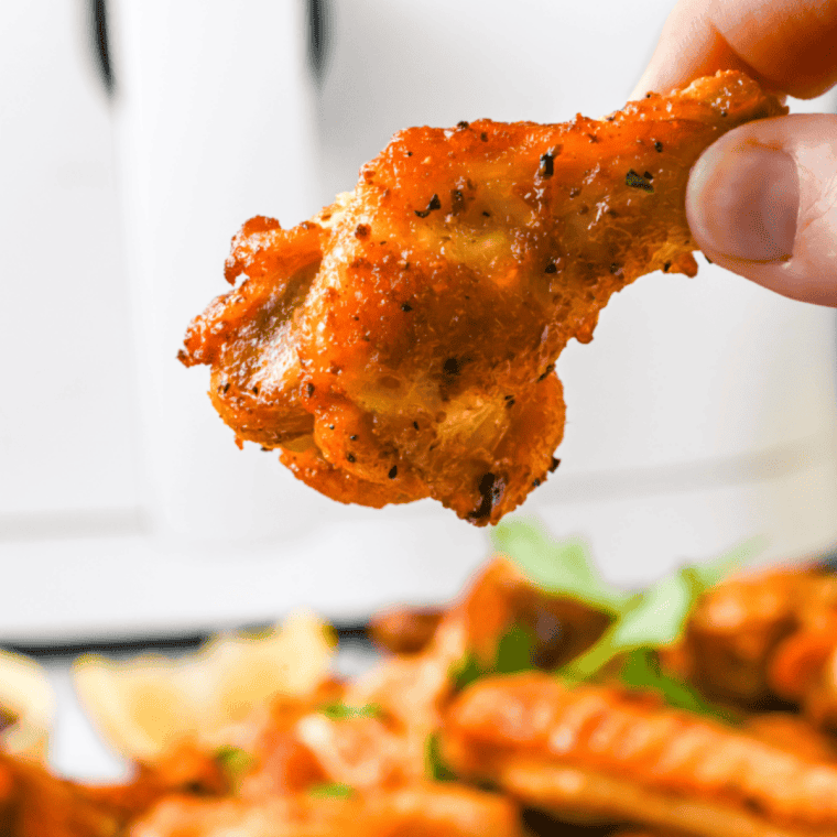 Bowl of homemade Wingstop Louisiana rub with chicken wings ready to coat