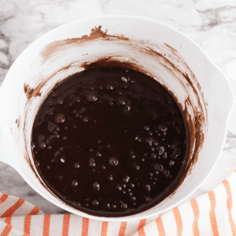 Mixing boxed brownie ingredients in a large bowl