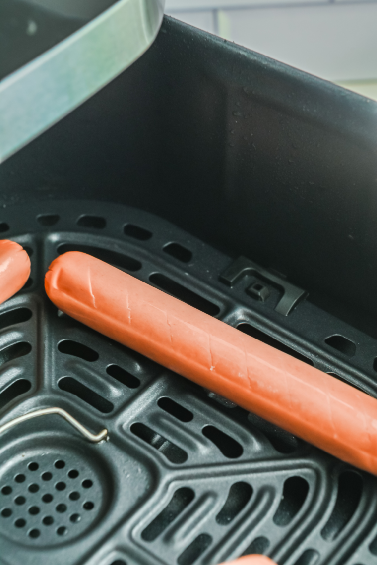 Air fryer preheated to 390°F creates lightly crisped, juicy hot dogs.