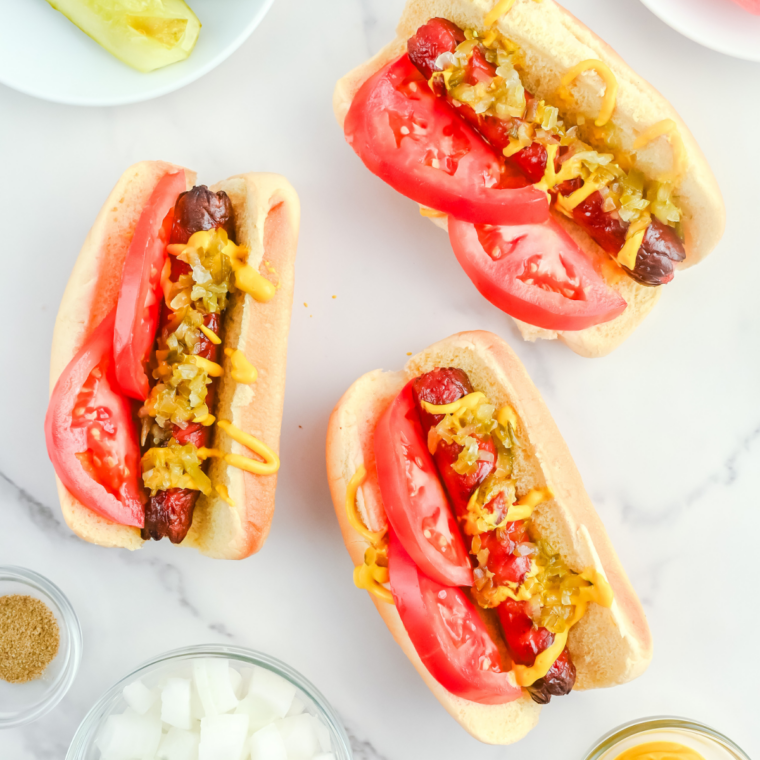 Chicago-style hot dog with mustard, relish, tomatoes, pickles, peppers, and a poppy seed bun made using air fryer method.