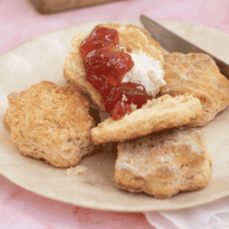 Air fryer scones — golden, fluffy lemonade scones served on a plate with fresh lemon slices