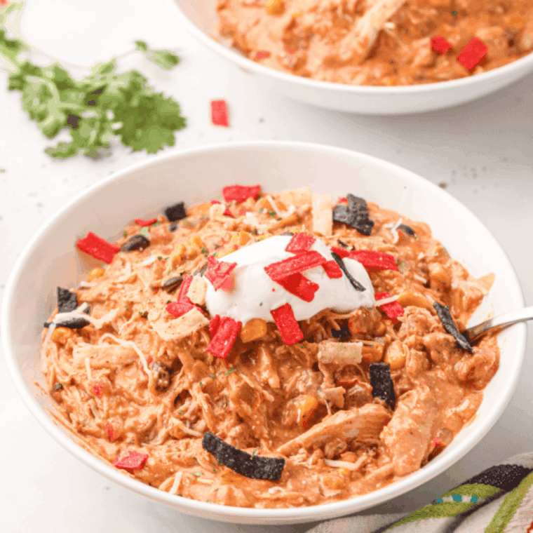 Homemade Copycat Crockpot Jason’s Deli Chicken Chili served in a bowl with beans and shredded chicken.