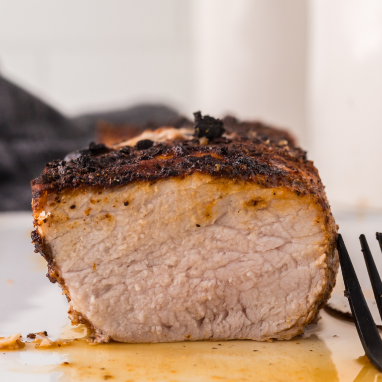 Sliced Ninja Foodi pork tenderloin, juicy and perfectly cooked, served on a plate