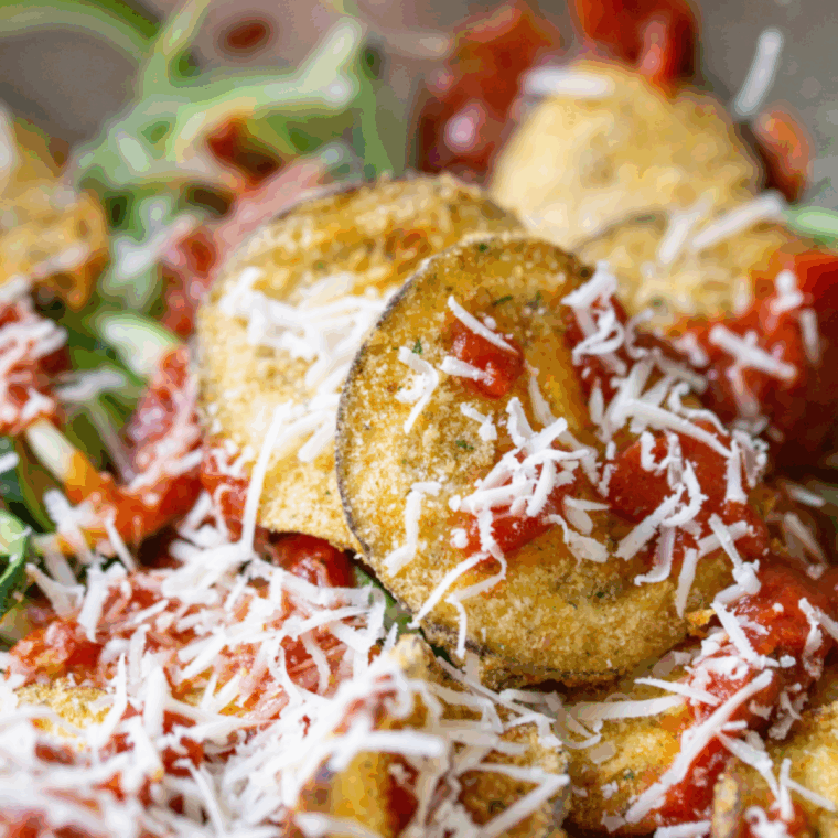 Golden, crispy air fryer eggplant chips served on a plate, ready to eat.