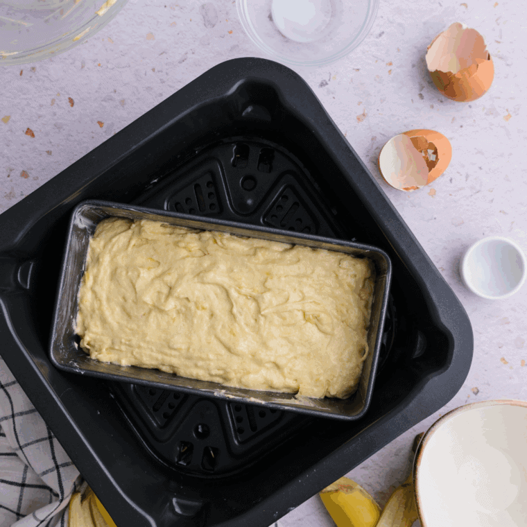 Greasing a baking pan with butter and pouring in banana bread batter evenly