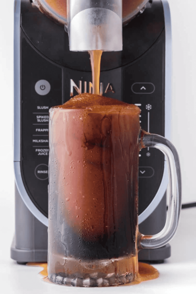 Glass of frosty Ninja Slushi Root Beer Float Slush topped with a scoop of vanilla ice cream and bubbles rising from the root beer.