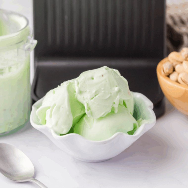 Creamy pistachio gelato served in a bowl with crushed pistachios on top, made using the Ninja Creami