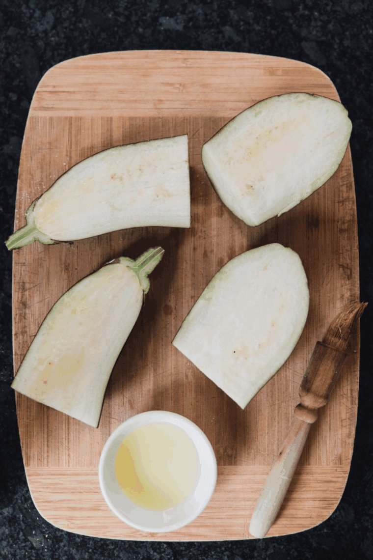 Preheating the air fryer to 400°F and brushing eggplant halves with olive oil before roasting