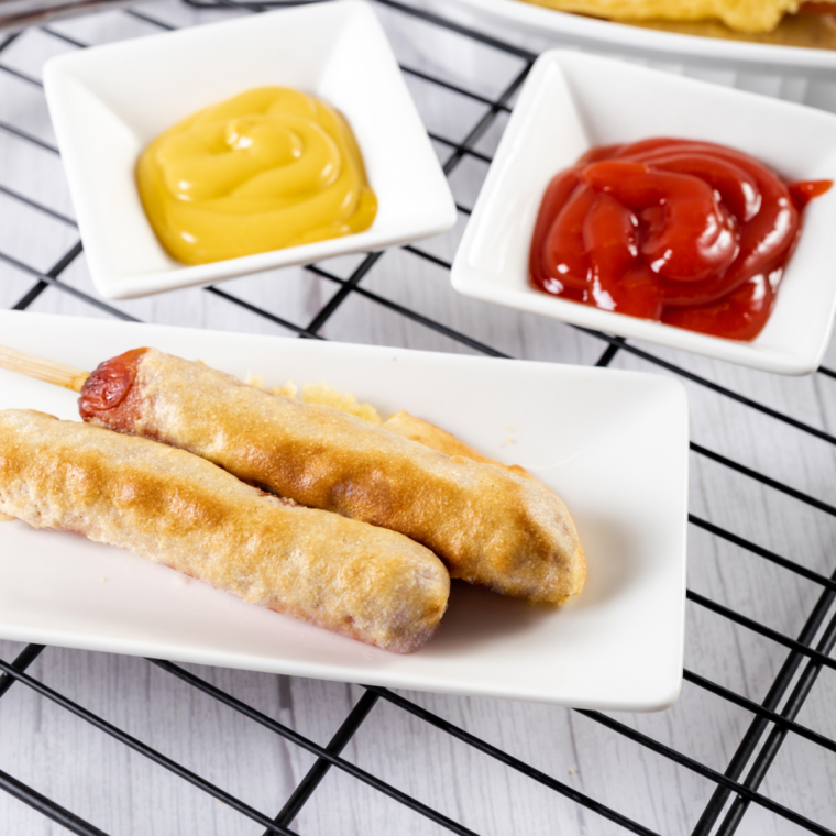Crispy homemade corn dogs fresh from the air fryer with dipping sauces on the side.