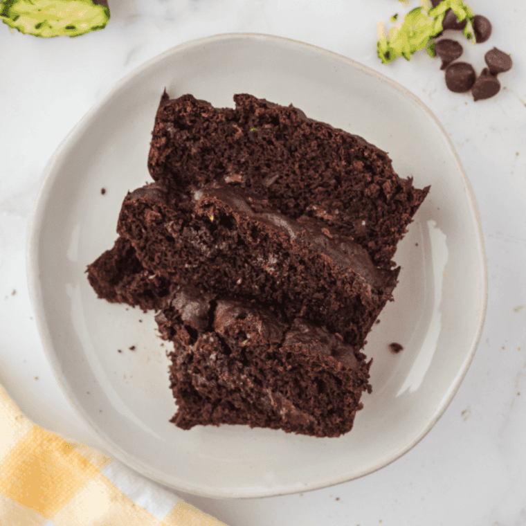 Air fryer chocolate chip zucchini bread slice on a plate with melty chocolate chips