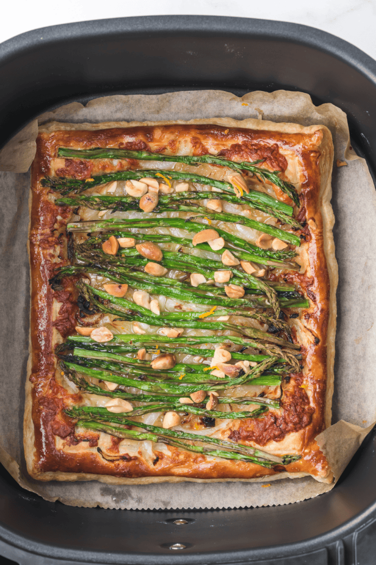Cooked Asparagus Tart in the air fryer basket.