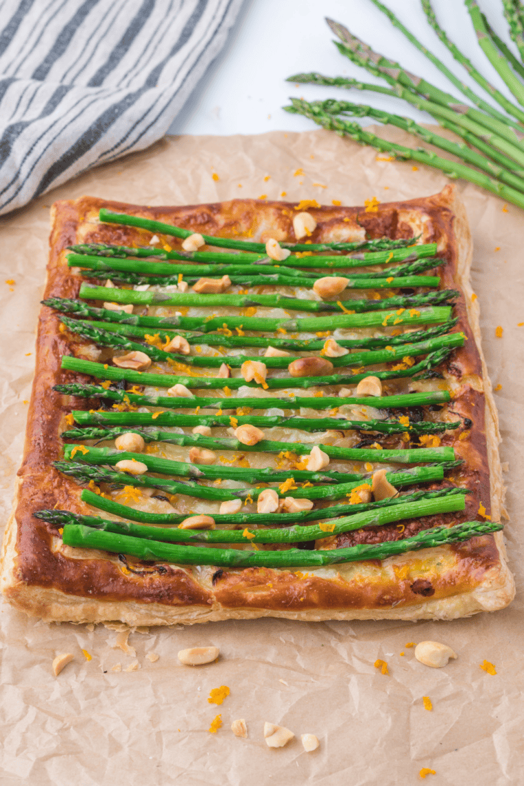 Golden air fryer asparagus tart topped with tender asparagus and melted cheese.