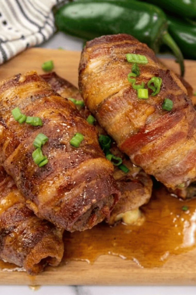 Crispy, golden-brown Air Fryer Armadillo Eggs on a serving plate with melted cheese inside.