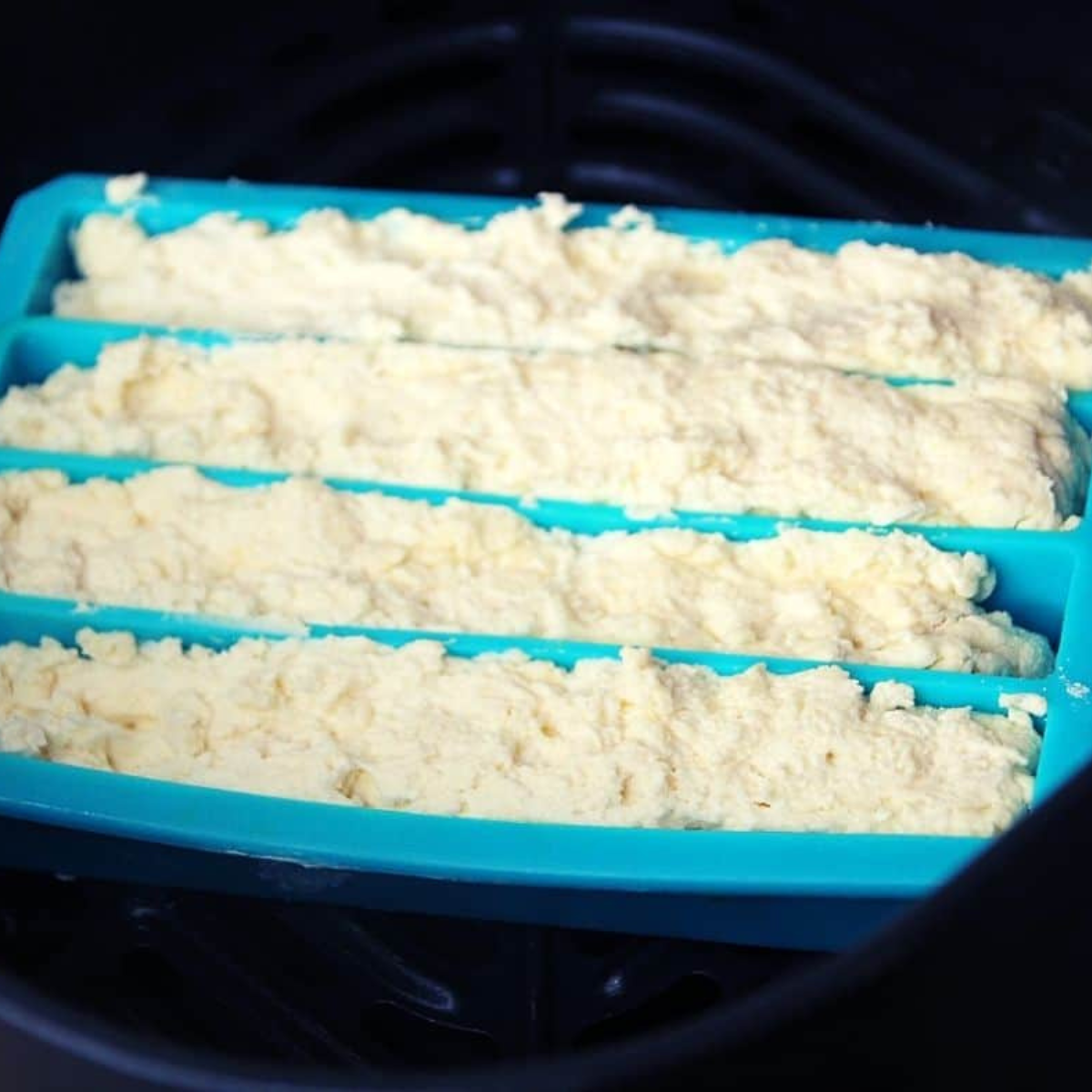 Dough spooned into mold placed in air fryer basket