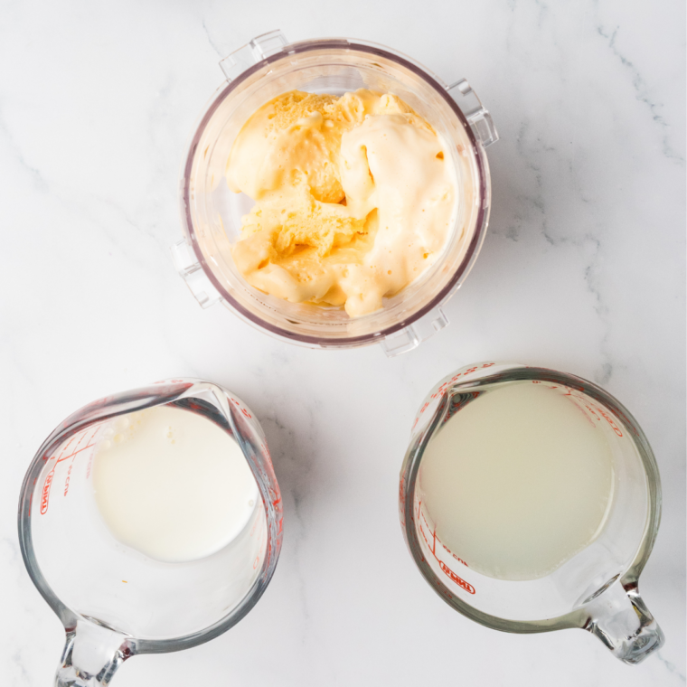 Ninja Creami Frosted Lemonade ingredients: Simply Lemonade, milk, and vanilla ice cream on a counter