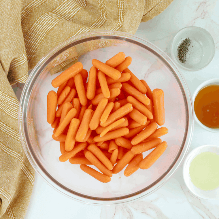 Ingredients needed for Texas Roadhouse Cinnamon Glazed Carrots Copycat Recipe on kitchen table.