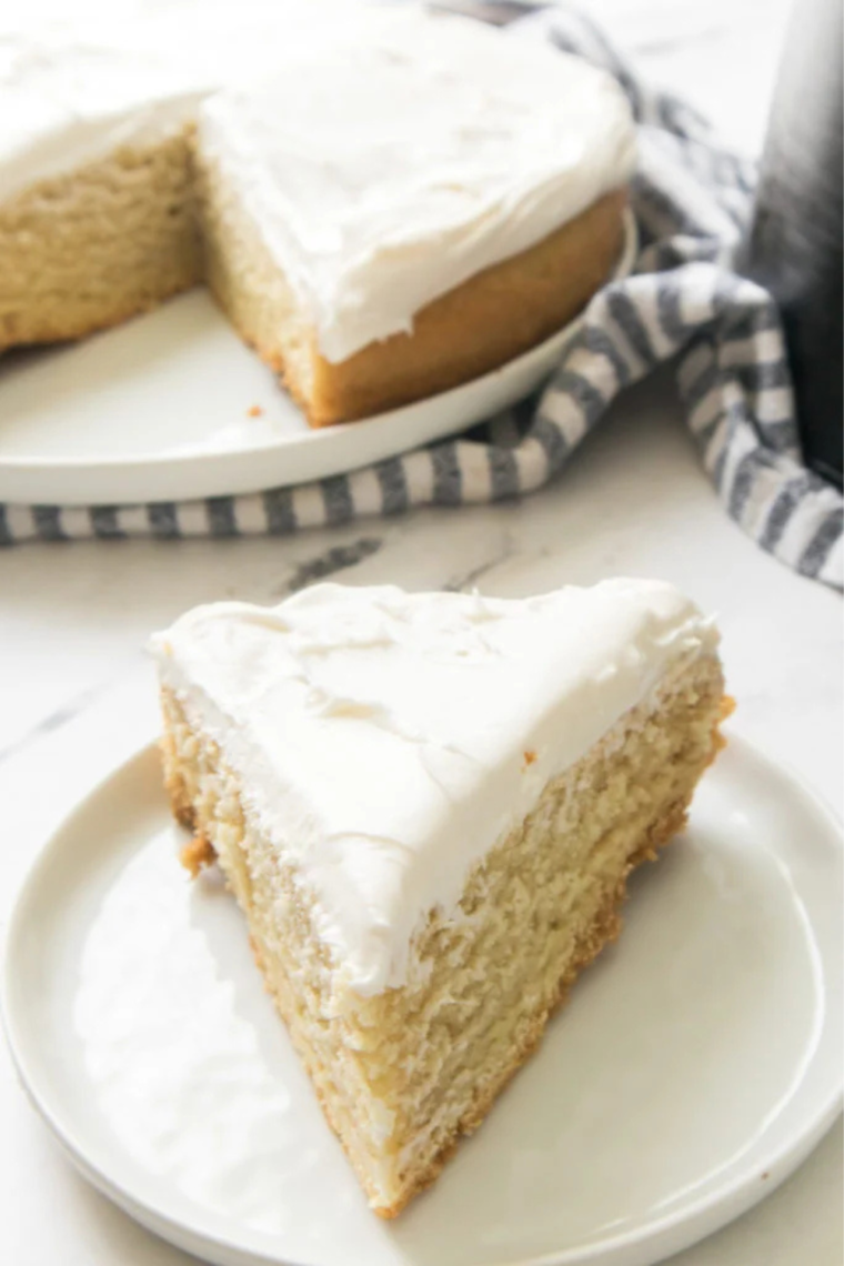 Delicious and fluffy Air Fryer Vanilla Cake, golden on the outside and moist on the inside, served with a light dusting of powdered sugar.