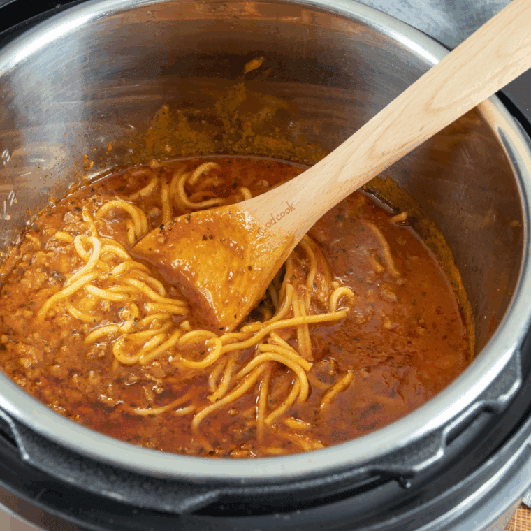 Tomato sauce, tomato paste, and diced tomatoes stirred into browned beef.