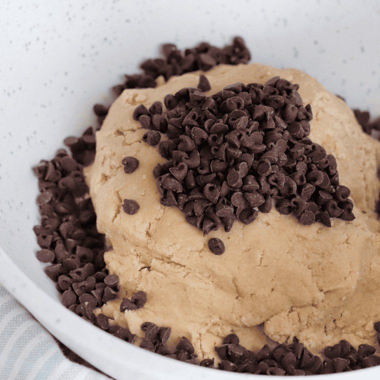 Folding chocolate chips into muffin batter with a spatula