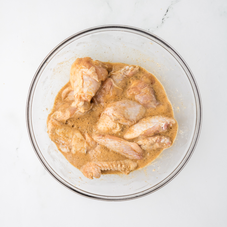 Chicken wings marinating in soy sauce and Shaoxing wine for Chinese chicken wings.