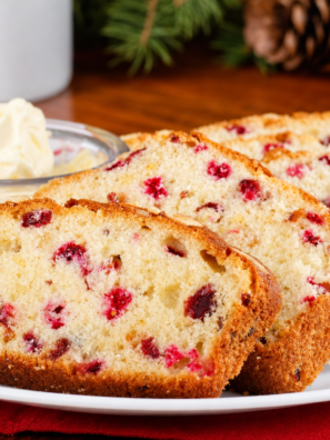 Sliced air fryer cranberry bread with orange glaze drizzled over the top