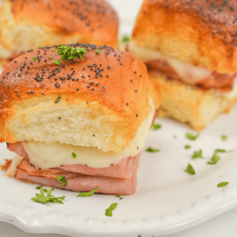Golden air fryer King’s Hawaiian ham and cheese sliders with melted cheese and sliced ham on soft Hawaiian rolls.