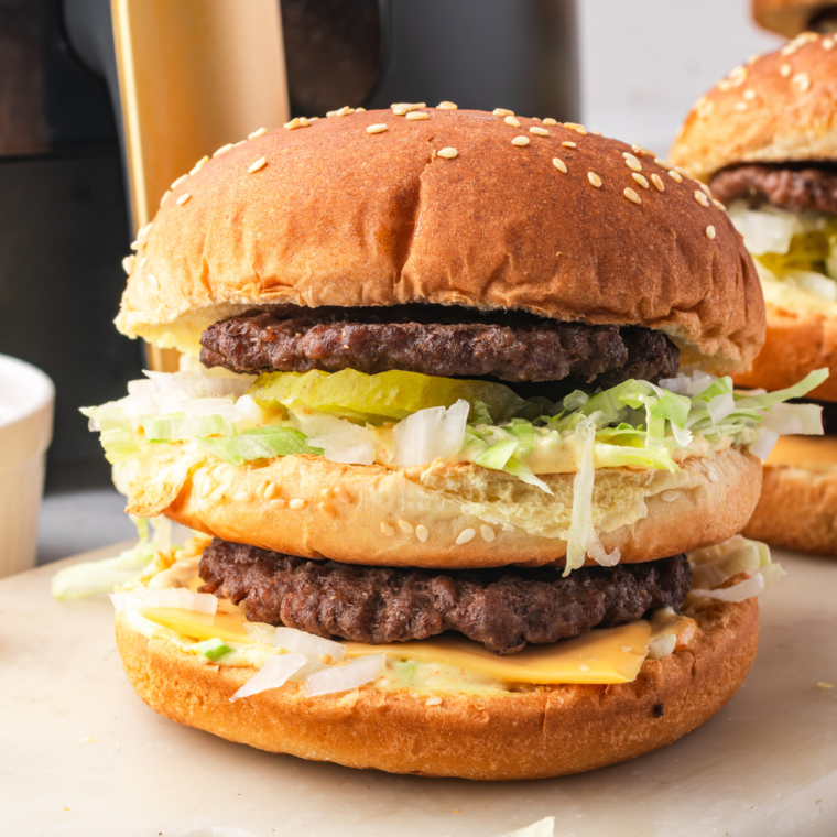 Homemade Big Mac with two beef patties, special sauce, lettuce, cheese, pickles, and onions on a sesame seed bun.