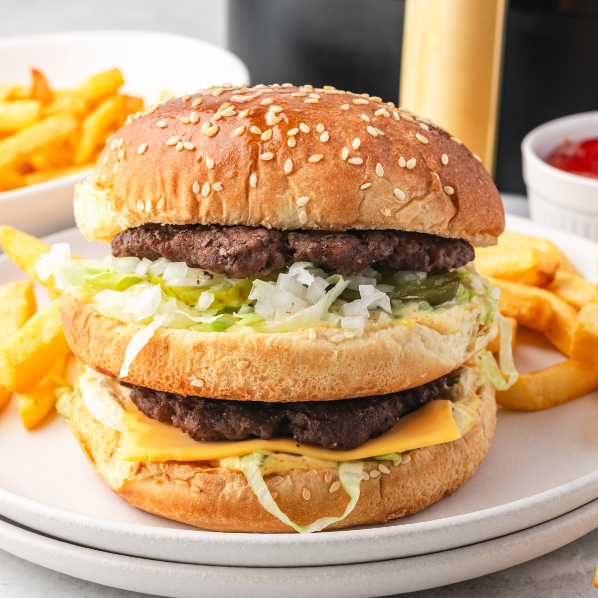 Homemade Big Mac stacked with beef patties, lettuce, cheese, and special sauce.