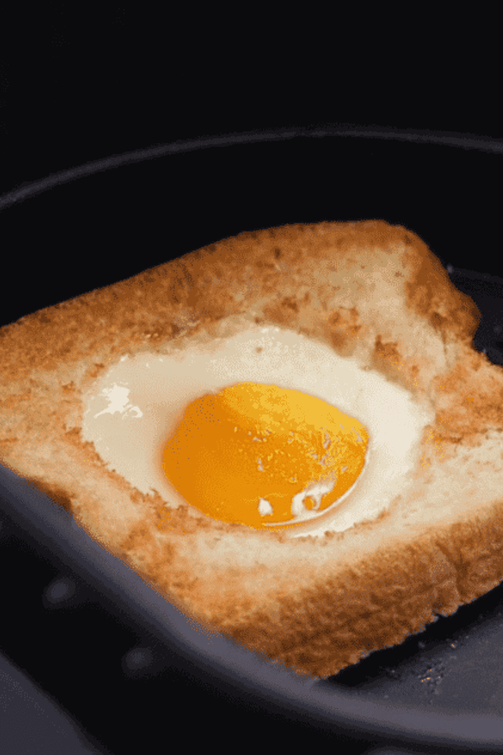 Golden bread with a perfectly cooked egg center made in the air fryer for a quick and tasty breakfast.