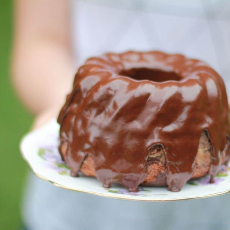 Fluffy Instant Pot box cake made from cake mix sliced on plate with soft moist crumb and frosting
