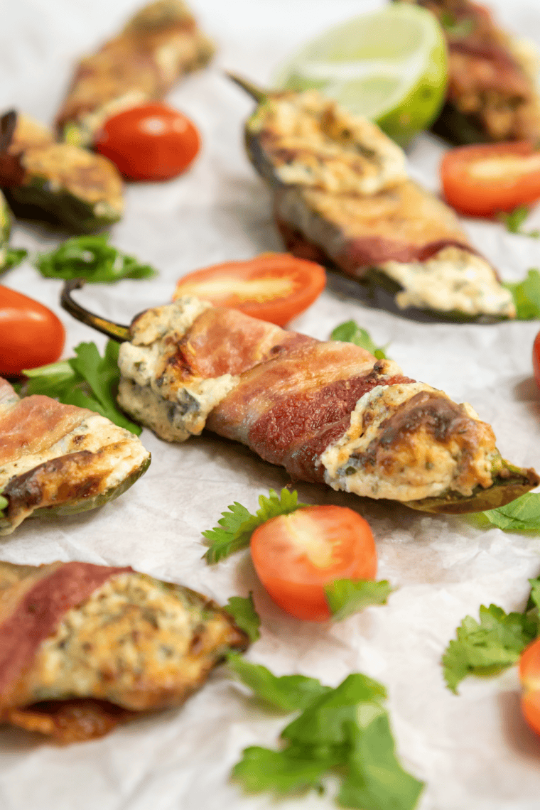 Crispy Air Fryer Bacon Wrapped Jalapeno Poppers on parchment paper