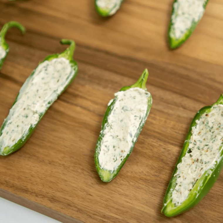 Prepare the JalapeƱos:
Slice the jalapeƱos in half lengthwise and remove the seeds and membranes. If you want less heat, ensure you remove all the seeds.
Make the Cream Cheese Filling:
Mix cream cheese, shredded cheddar cheese, garlic powder, paprika, and a pinch of salt until well combined.
