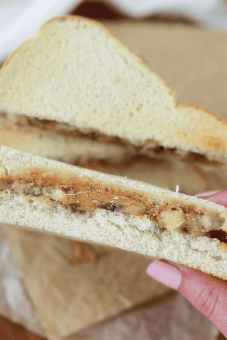 Crispy air fryer peanut butter banana sandwich with melted peanut butter and soft banana slices inside.