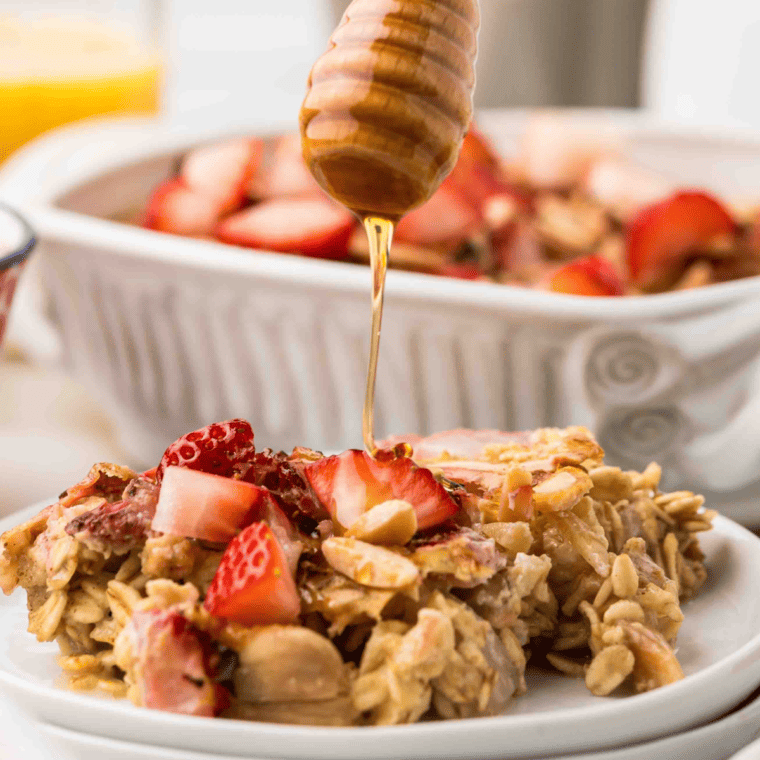 Reheated oatmeal on a plate being drizzled with honey