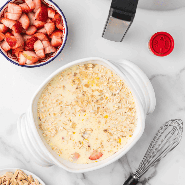 Poured strawberry oatmeal in an air fryer safe baking dish.